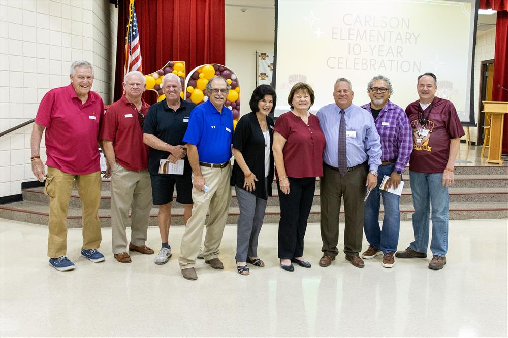 Special guests smile for a photo before Carlson Elementary School's 10th Anniversary Ceremony.